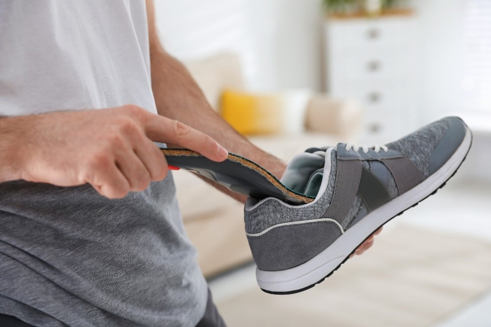 Placing orthotics into shoes for diabetic foot care