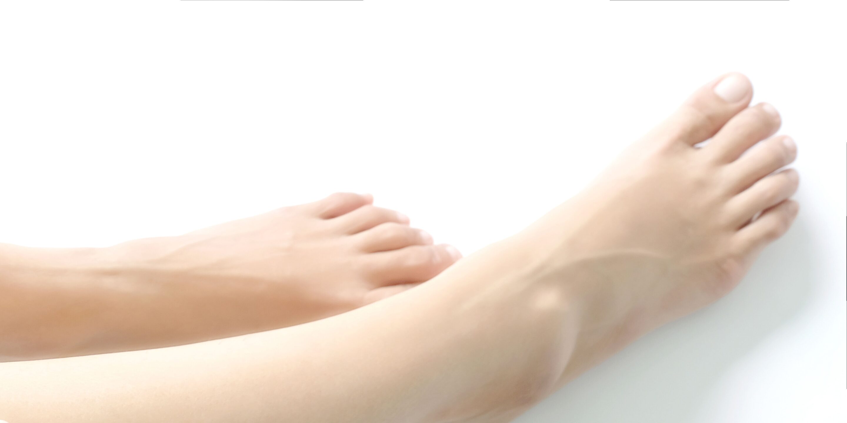 female legs and feet on a white background. Concept beauty and hydration of the skin.